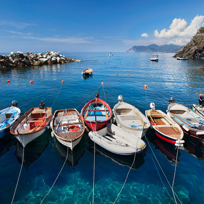 Boats lined up in a harbor in Cinque Terre, Italy.