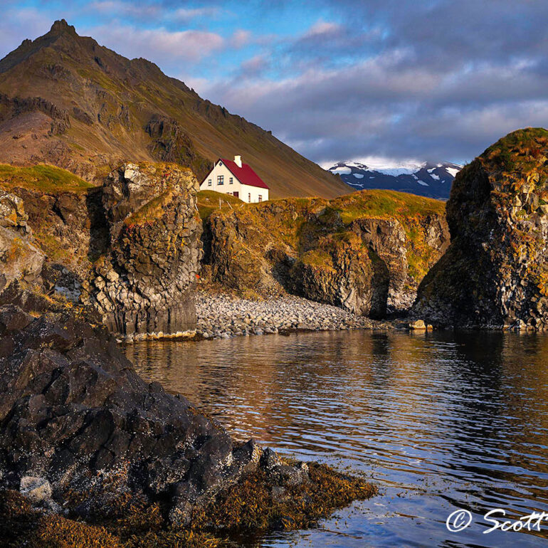 Lone house in front of a mountain.