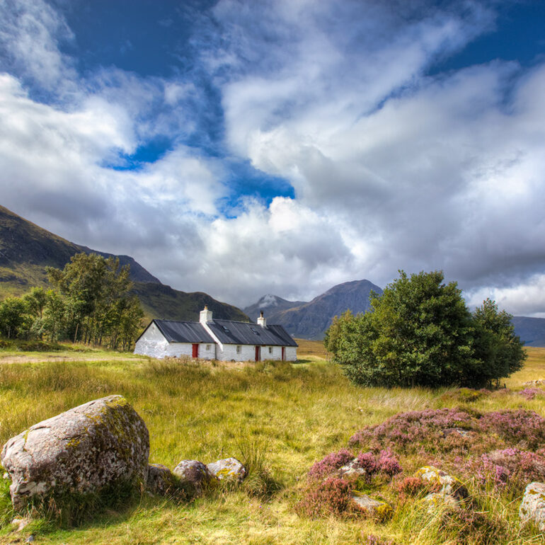 A cottage set in a vally in the Highlands.