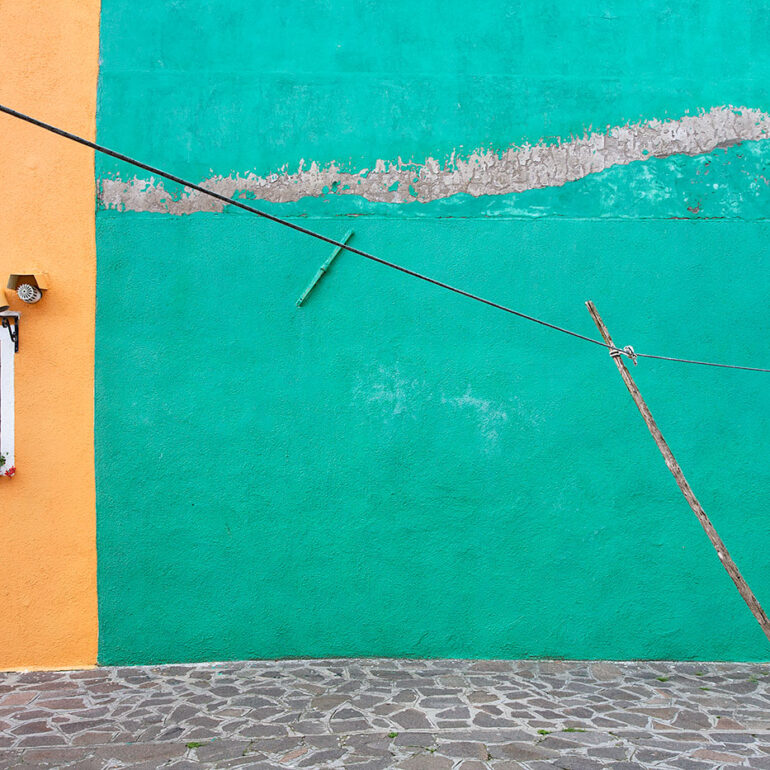A clothes line set against peeling paint.
