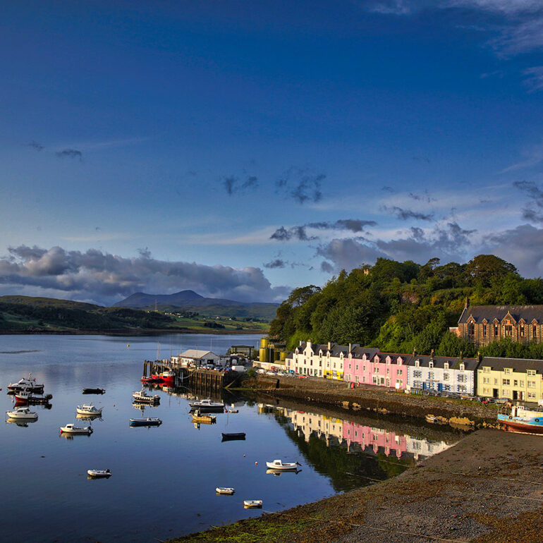 Colorful fishing village harbor at sunrise.