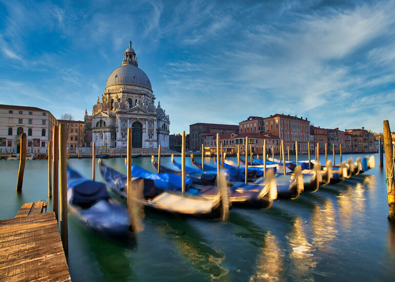 Early morning in Venice with gondolas shinning in the sun.