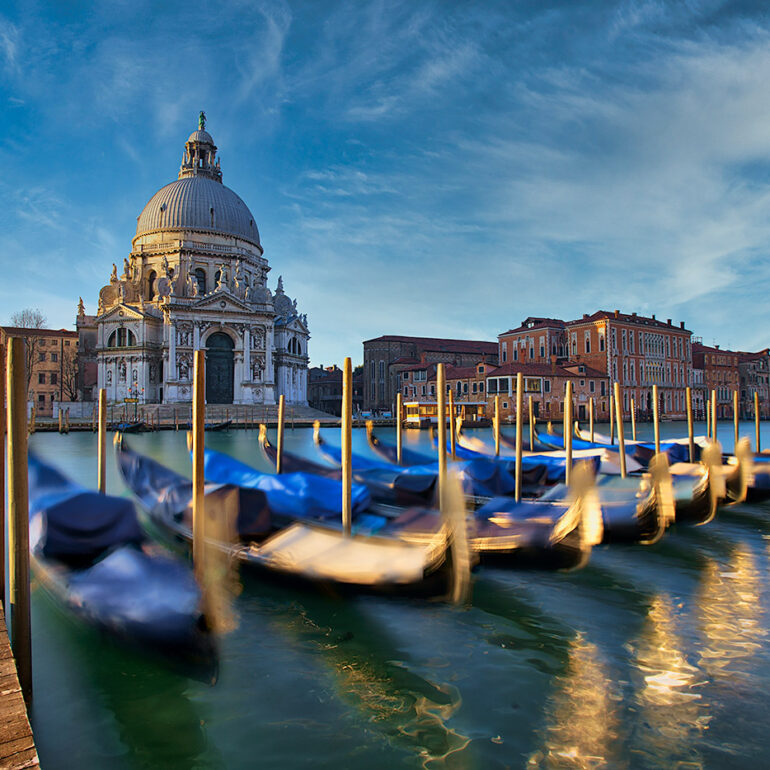 Early morning in Venice with gondolas shinning in the sun.