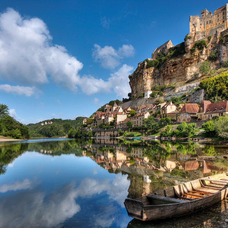 River view of the Dordogne Valley with a castle on the hill.