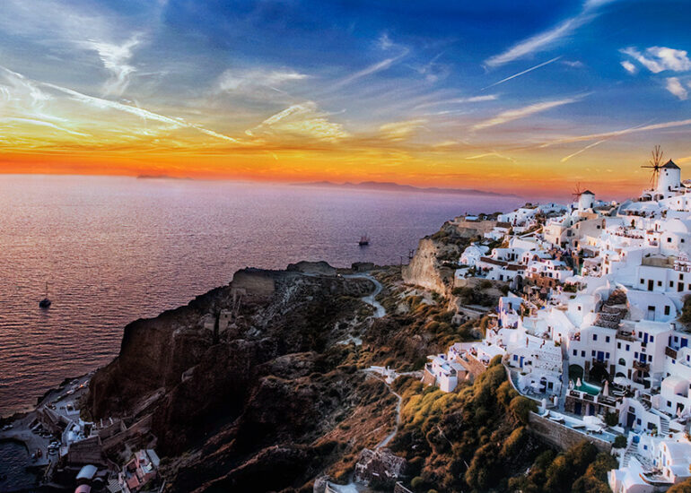 A stunning sunset accompanies the town of Ioa.