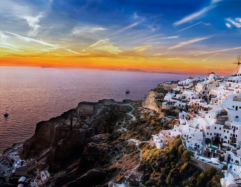 A stunning sunset accompanies the town of Ioa.