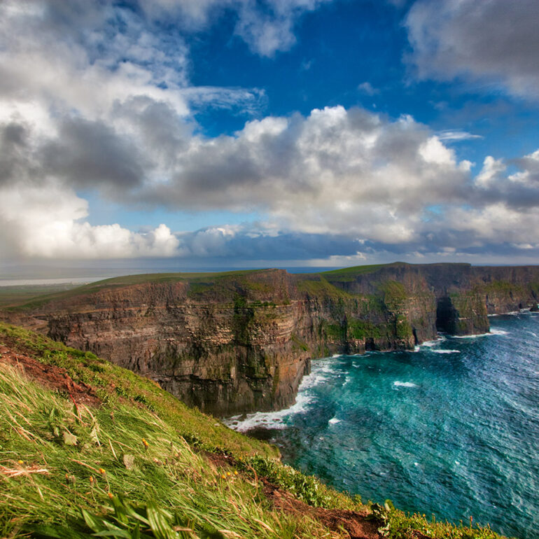 Rugged cliffs with a rainbow after a storm.