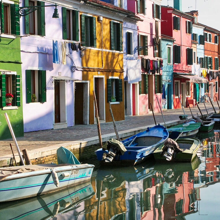 Colorful painted houses along a canal.